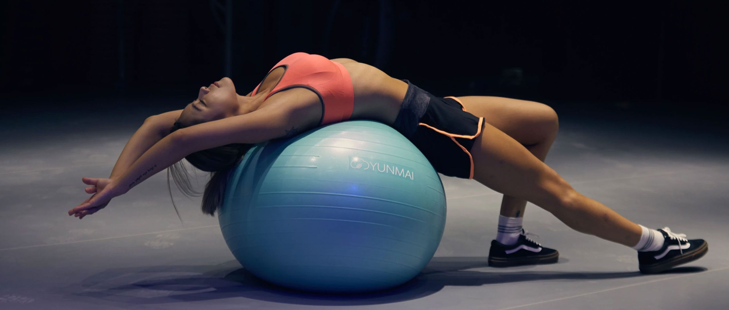 Woman Stretching Over a Gym Ball